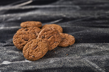 Image showing Double chocolate chip fresh cookies heap on black background.