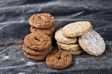 Image showing Chocolate chip and oat fresh cookies with sugar powder stacks 