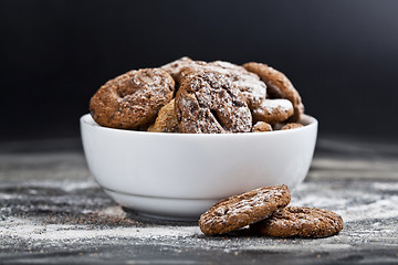 Image showing Fresh baked chocolate chip and oat fresh cookies with sugar powd