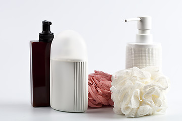 Image showing Bath cosmetic products and sponges on light background. 
