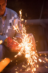 Image showing the blacksmith polishing metal products