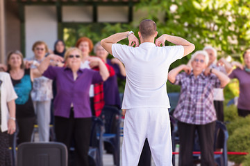 Image showing trainer training motivated active healthy senior people