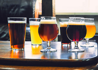 Image showing Glasses of different kinds of beer on wooden background