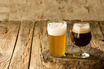 Image showing Glasses of different kinds of beer on wooden background