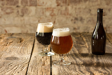 Image showing Glasses of different kinds of beer on wooden background