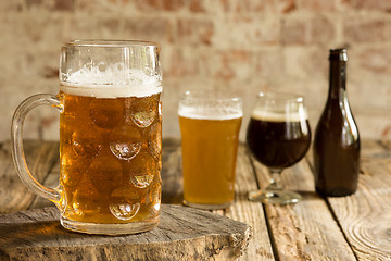 Image showing Glasses of different kinds of beer on wooden background