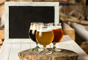 Image showing Glasses of different kinds of beer on wooden background