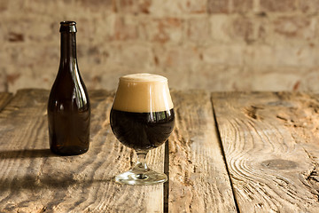 Image showing Glasses of different kinds of beer on wooden background