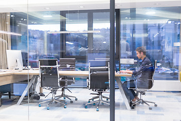 Image showing young businessman relaxing at the desk