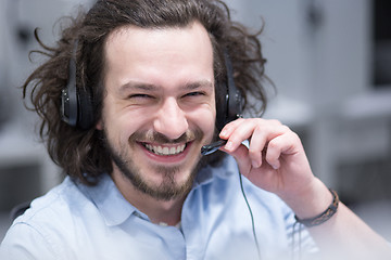 Image showing male call centre operator doing his job