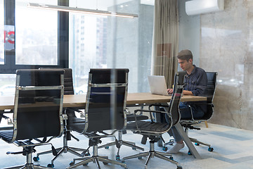 Image showing businessman working using a laptop in startup office