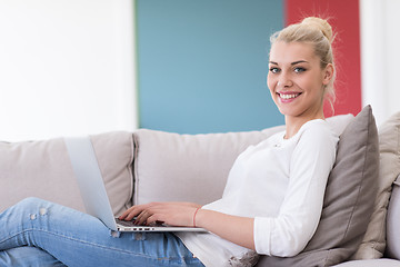 Image showing Young woman using laptop at home
