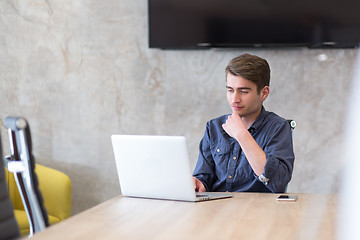 Image showing businessman working using a laptop in startup office