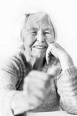 Image showing Happy 96 years old elderly woman giving a thumb up and looking at camera.