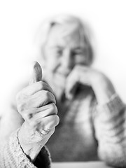 Image showing Happy 96 years old elderly woman giving a thumb up and looking at camera.