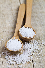 Image showing Wooden spoons with sea salt closeup on wooden rustic table.