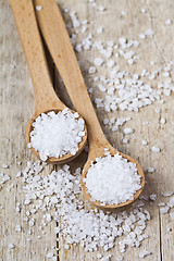 Image showing Wooden spoons with sea salt closeup on wooden rustic table.