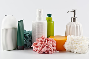 Image showing Bath cosmetic products set and sponges on light background. 