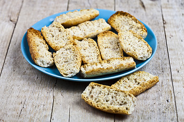 Image showing Fresh italian croutons crostini on blue plate.