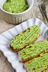 Image showing Fresh crostini with avocado guacamole on white plate closeup on 