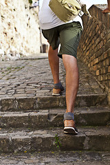 Image showing Walking upstairs: closeup view of man's legs brown leather shoes