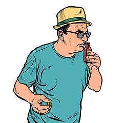 Image showing a man sniffs a bottle. perfume or medicine