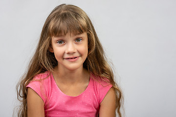 Image showing Portrait of a surprised beautiful eight-year cheerful European girl