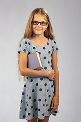 Image showing Schoolgirl in glasses with a book in her hands