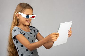 Image showing The girl is looking at the colored 3D glasses made using the anaglyph technology of 3D glasses
