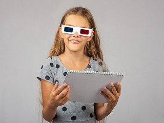 Image showing The girl in the colored 3D glasses, made using the anaglyph technology of the 3D glasses, looked into the frame