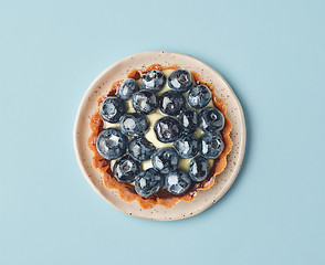 Image showing blueberry tart on light blue background