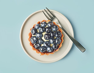 Image showing blueberry tart on light blue background