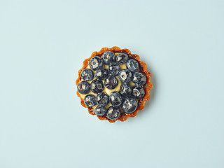 Image showing blueberry tart on light blue background