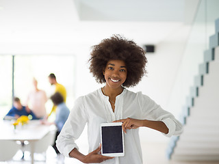 Image showing Portrait of  black casual businesswoman using tablet  with cowor