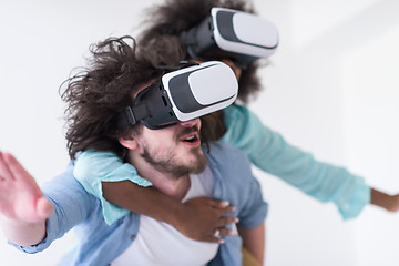 Image showing multiethnic couple getting experience using VR headset glasses