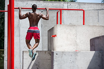 Image showing Athlete doing exercises at stadium