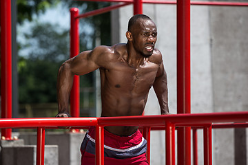 Image showing Athlete doing exercises at stadium