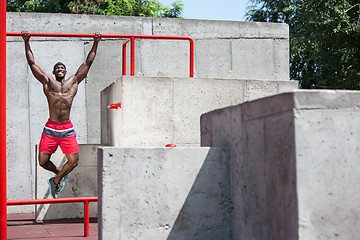 Image showing Athlete doing exercises at stadium