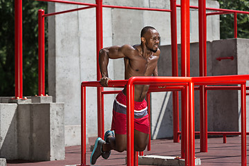 Image showing Athlete doing exercises at stadium