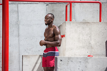 Image showing Athlete doing exercises at stadium