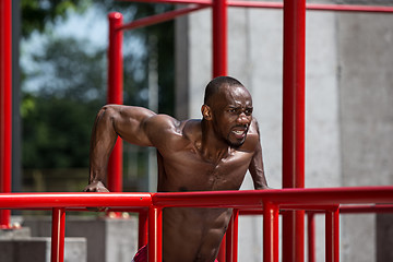 Image showing Athlete doing exercises at stadium