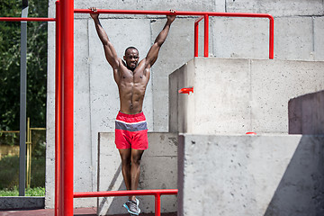 Image showing Athlete doing exercises at stadium