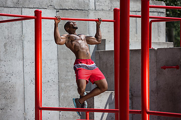 Image showing Athlete doing exercises at stadium