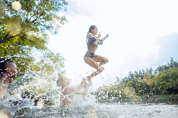 Image showing Enjoying river party with friends. Group of beautiful happy young people at the river together