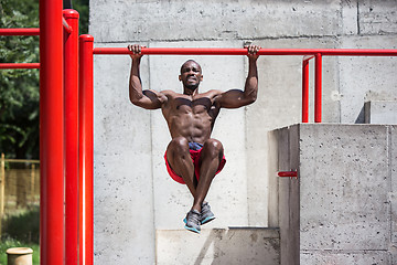 Image showing Athlete doing exercises at stadium