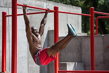 Image showing Athlete doing exercises at stadium