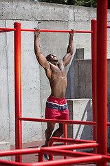 Image showing Athlete doing exercises at stadium