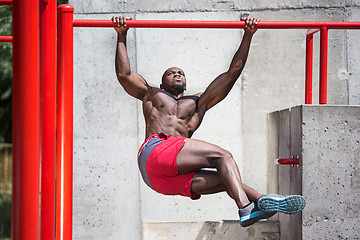 Image showing Athlete doing exercises at stadium