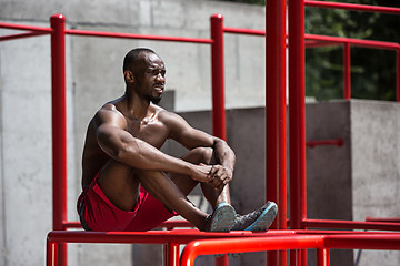 Image showing Athlete doing exercises at stadium