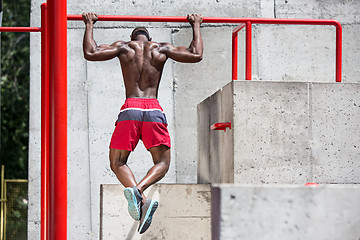 Image showing Athlete doing exercises at stadium